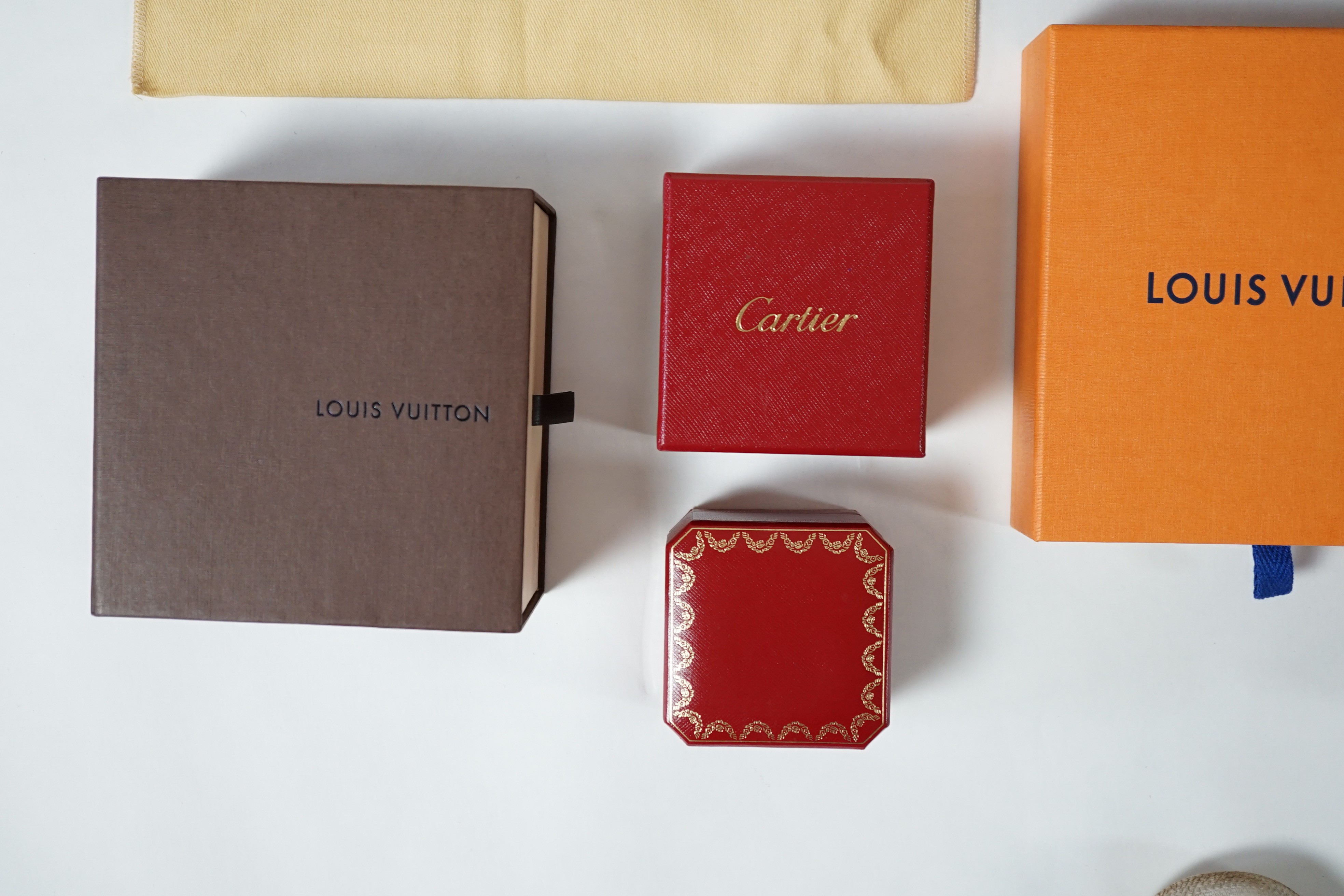 A selection of empty designer boxes including Cartier, Louis Vuitton and Chopard